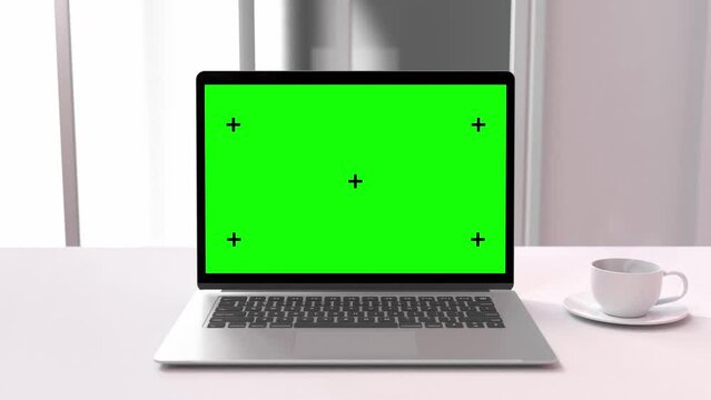 Laptop Mock-Up. computer with Green screen on work desk and cup coffee in office white room. Designed in minimal concept. Can be used in education or business background. Animation, 3D Render.