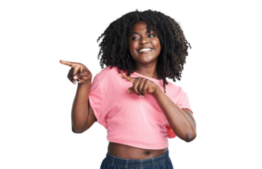 An attractive young woman pointing at copy space isolated on a PNG background.