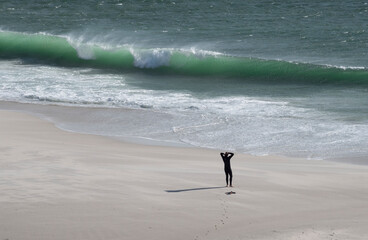 Lone surfer or swimmer preparing to confront fears, and  danger of a challenge of rough sea and...