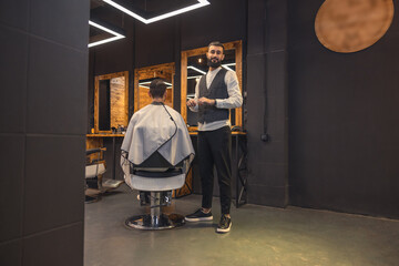 Male barber combing the clients hair