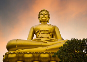 Golden Big Buddha or Wat Paknam Bhasicharoen at sunset. It is on the banks of the Chao Phraya River. It is one of the most important travel destinations in Bangkok. © daphnusia