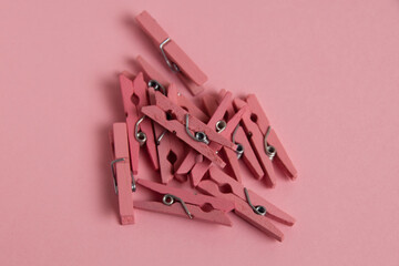 Flatlay, pink, wooden clothespins on paper background