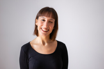 Obraz premium Portrait of a girl on white background. Brown short hair girl. Content girl winking