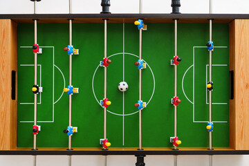 Top view of a table football game in progress