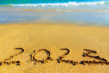 Inscription 2023 on the beach . Summer vacation in 2023