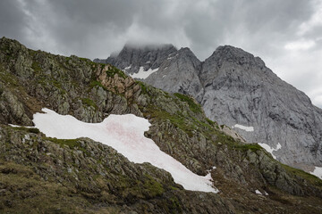Between Italy and Austria: on the top of mountain near Volaia Lake Raunchkofer Mountain (Lago di Volaia Monte). Mountain hiking Trail Road.
