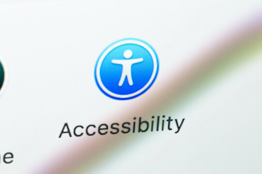 Accessibility settings icon on display MacBook closeup. Apple Accessibility settings for users who are blind or low vision. Batumi, Georgia - December 11, 2022