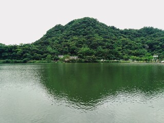Fototapeta na wymiar Green mountain with reflection in lake