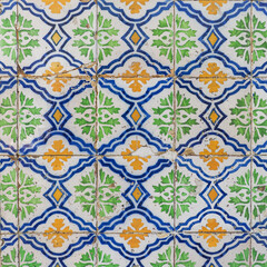 Damaged, dirty, not corrected, vintage azulejos, glazed ceramic tiles with ornaments on building wall. Heritage Concept of traditional Portuguese art.
