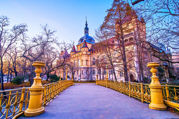 The yellow bridge in City Park leading to Vajdahunyad Castle, the great complex in the heart of Budapest, Hungary