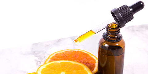 Vitamin C serum bottle with dropper on white marble background - 564616969