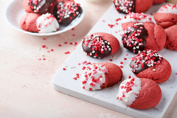 Valentines day cookies. Shortbread cookies with glaze white and dark chocolate and heart sprinkles on plate on pink background. Mothers day. Womans day. Sweet holidays baking. Top view.