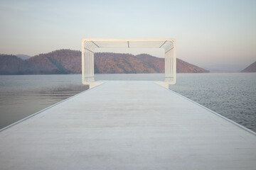 A large rectangular shape, a viewpoint of a resort with mountains and water surrounding it, slightly foggy