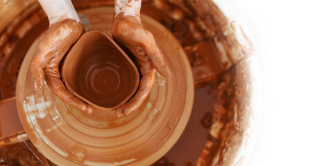 Master making a pot on pottery wheel, top view,banner