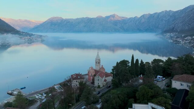 Temple in the Coast of Kotor bay. Aerial view. Morning time. Fog over the water
