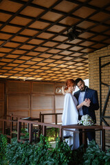 Fototapeta premium bride in a white dress with a bouquet and the groom in a blue suit