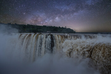 Stunning Night View of Iguacu Waterfalls in Brazil with Stars and Milky Way. Beautiful Natural Scenery in South America