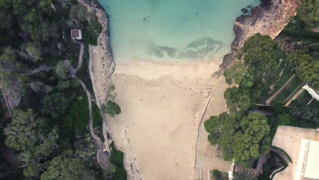 aerial recording of beautiful beach of mallorca, white sand, translucent turquoise sea, cala dor,mallorca, balearic islands spain, droone view
