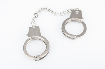 Metal handcuffs on a white background