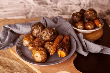 Healthy baked vegetables - carrots, potatoes, beetroot, rustic background. Whole food diet, Dash diet