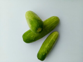 Green cucumbers on a white background