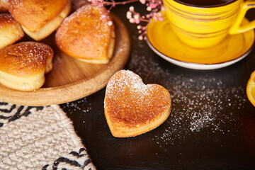 Aesthetics homemade heart shaped muffins with orange flavour for Valentines Day. Tea time, yellow cups