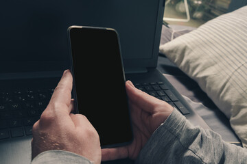 close-up, hands holding a mobile. black screen
