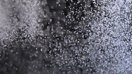 burst of transparent particles resembling water splash on black background. 3D rendering