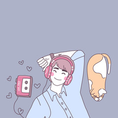 Young man listens to love song by wearing headphones. And there was a cat lying next to it