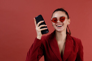 Young laughing woman hearing portable wireless speaker. Listening bluetooth music and dancing.