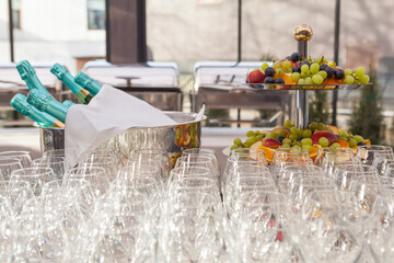 Row of glasses, a bowl of fruit. Bar counter. Banquet
