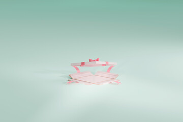 White gift box on mint green stage with pink ribbon and bow. Empty open view for marketing advertisement purpose, can be fitted with product.