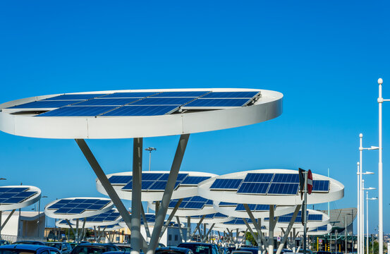 solar power plant with big antennas on a parking for charging electrocars, problems of car energy of future
