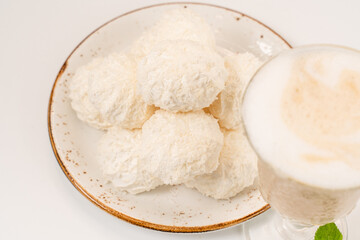 marshmallows on pink plates, with a cup of hot cocoa on a white background.