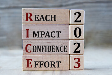 REACH IMPACT CONFIDENCE EFFORT 2023 - words on wooden blocks on gray background