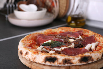 Frozen pizza with beef in the kitchen