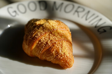 Croissants on white plate with morning light