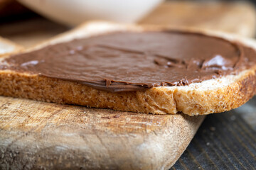Chocolate butter spread on bread while cooking breakfast
