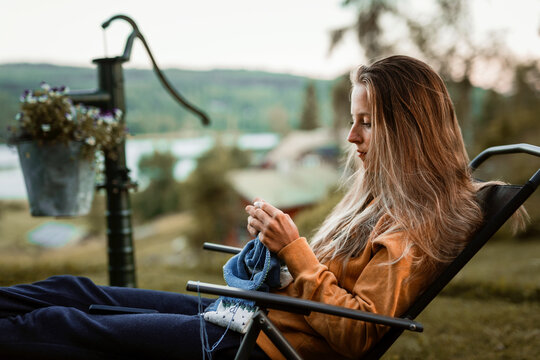 Smiling woman knitting