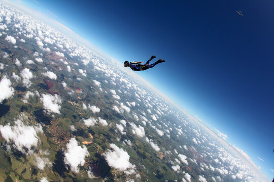 Single skydiver in freefall against a clear blue sky on a sunny day