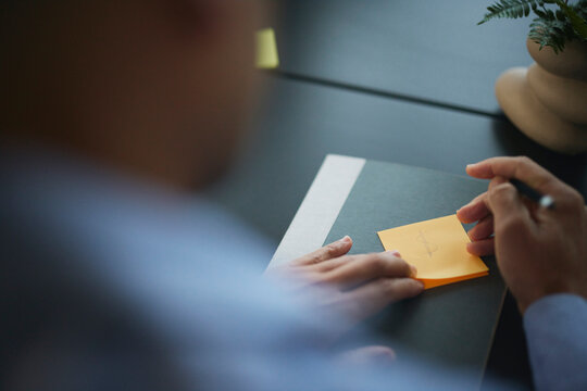 Man Taking Notes During Meeting