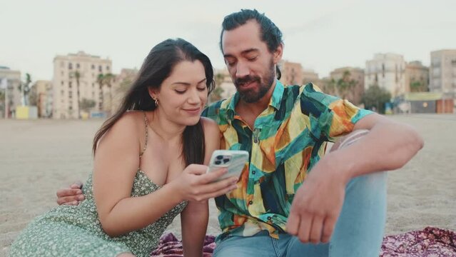 Romantic couple looking at photos on mobile phone