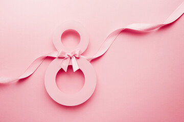 March 8 greeting card. Paper number 8 on a pink background with a ribbon and a bow
