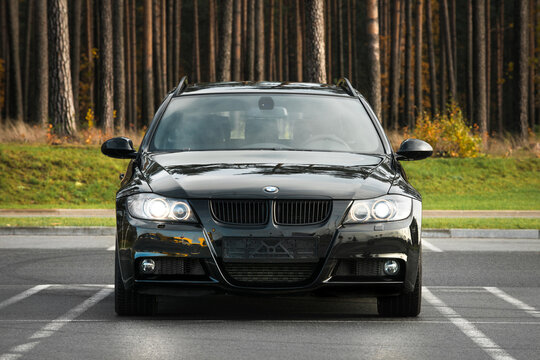 Switzerland, Bern - OCTOBER 29, 2020. Black BMW 330d xDrive Touring e90, 3.0 T.D, xDrive. Turbo diesel. 2011 year model. Car on parking place near forest. Front view.