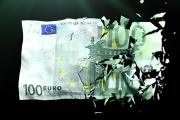 Broken Euro paper money on a green background