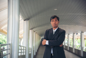 Fototapeta premium Portrait happiness businessman smiling face confident leader manager in modern city. Asian man handsome success look at camera professional manager. Men standing in suit handsome CEO leader business