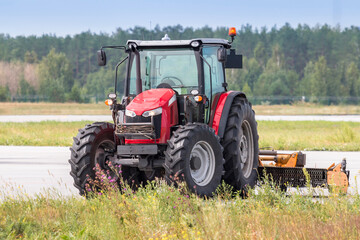 Wheeled tractor with rotary mower on the road