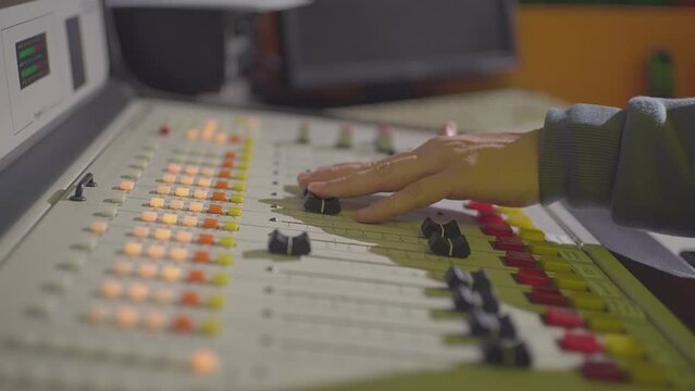 a man in a radio station studio works with an equalizer. High quality Full HD video recording