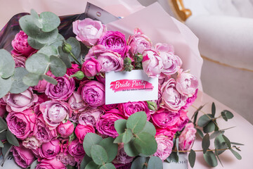 Invitations for a bachelorette party on the background of a bouquet of roses.