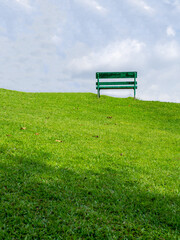 chair lounge on the green grass that sits on a fresh green hill